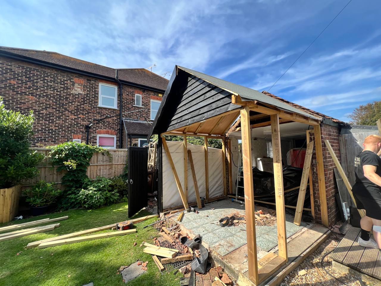  external partially built garden room showing framework and black cladding 